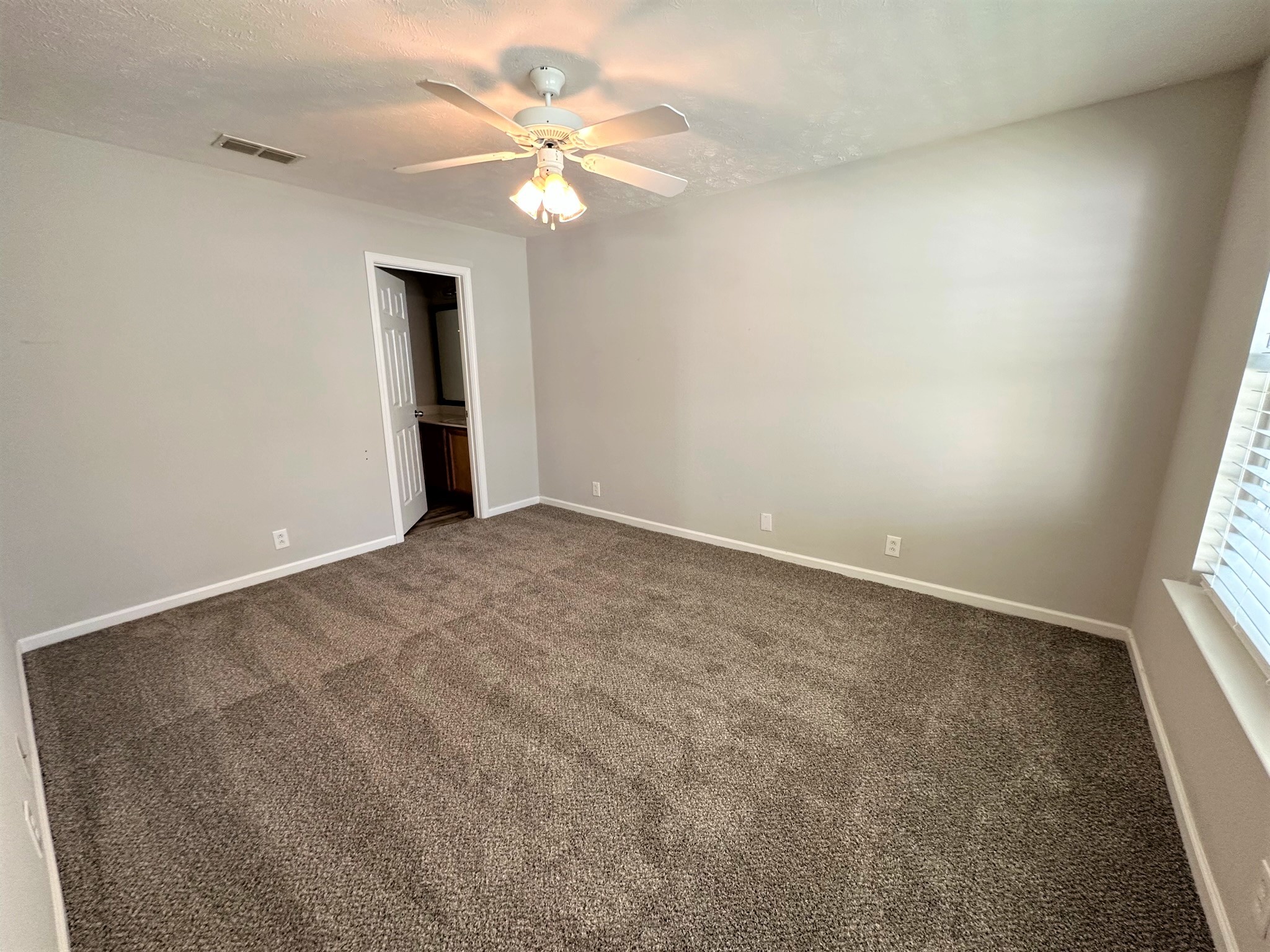 113 Lancaster Gate Place Murfreesboro, TN 37128 - Photo 10 of 28 an empty room with a chandelier fan and windows