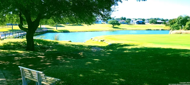 a view of a table and chairs under an umbrella