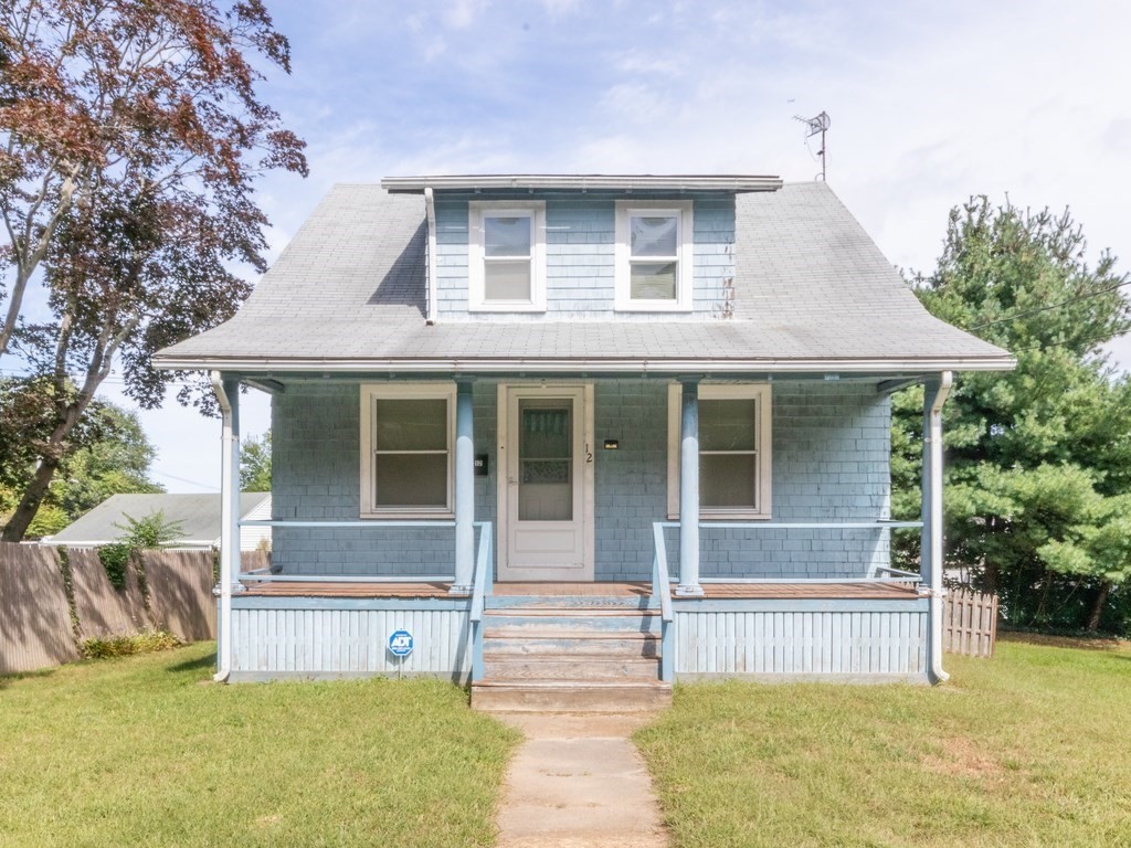 a front view of a house with a garden and plants