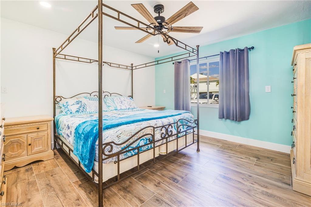 4817-4819 Gary Road Bonita Springs, FL 34134 - Photo 15 of 48 a bedroom with a bed and wooden floor