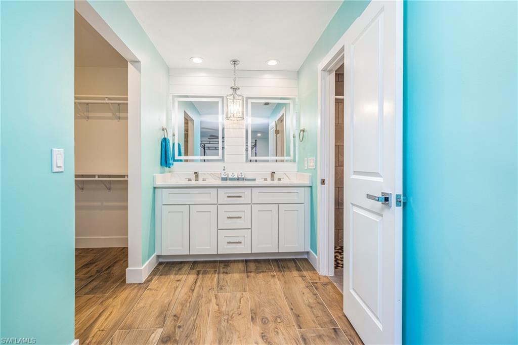 4817-4819 Gary Road Bonita Springs, FL 34134 - Photo 17 of 48 a bathroom with a sink a mirror and a shower