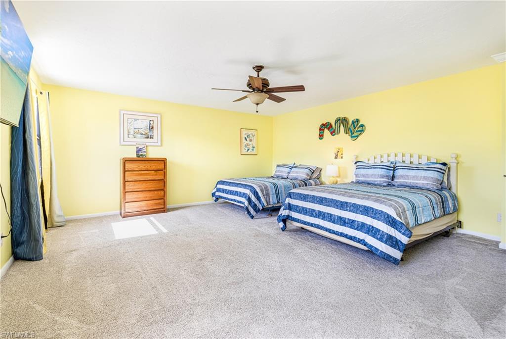 4817-4819 Gary Road Bonita Springs, FL 34134 - Photo 18 of 48 a bedroom with a bed and a chandelier