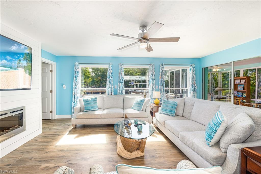 4817-4819 Gary Road Bonita Springs, FL 34134 - Photo 2 of 48 a living room with furniture and a fireplace