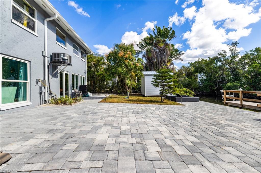 4817-4819 Gary Road Bonita Springs, FL 34134 - Photo 22 of 48 a view of a building with floor to ceiling windows and potted plants