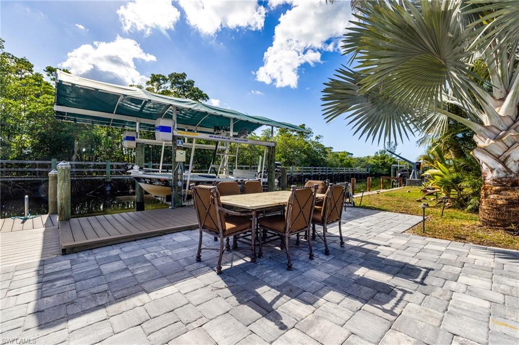 4817-4819 Gary Road Bonita Springs, FL 34134 - Photo 23 of 48 a view of a patio with a table and chairs