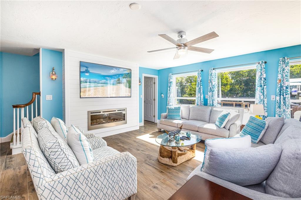 4817-4819 Gary Road Bonita Springs, FL 34134 - Photo 3 of 48 a living room with furniture a fireplace and a large window