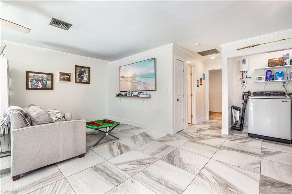 4817-4819 Gary Road Bonita Springs, FL 34134 - Photo 31 of 48 a living room with furniture and kitchen view