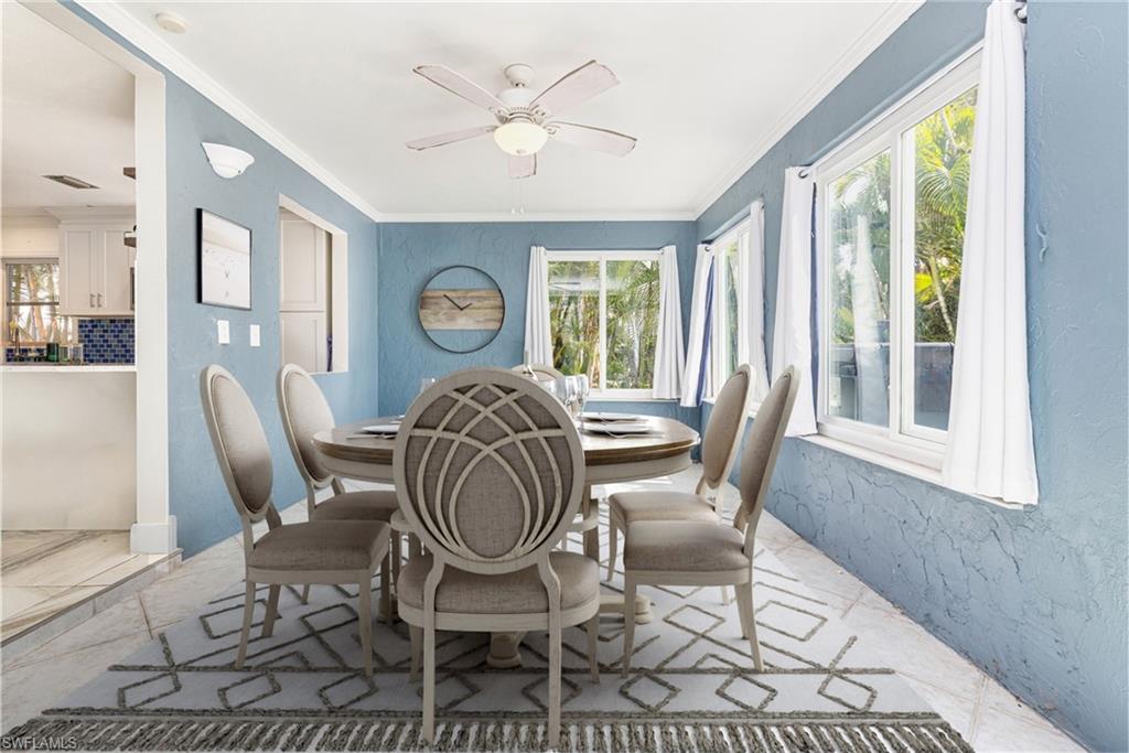 4817-4819 Gary Road Bonita Springs, FL 34134 - Photo 37 of 48 a dining room with furniture a rug and a large window