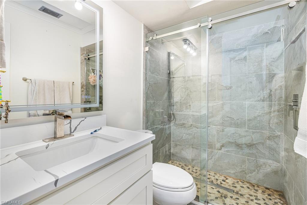 4817-4819 Gary Road Bonita Springs, FL 34134 - Photo 38 of 48 a bathroom with a sink mirror toilet and shower