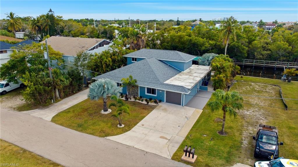 4817-4819 Gary Road Bonita Springs, FL 34134 - Photo 43 of 48 an aerial view of a house with a garden and swimming pool