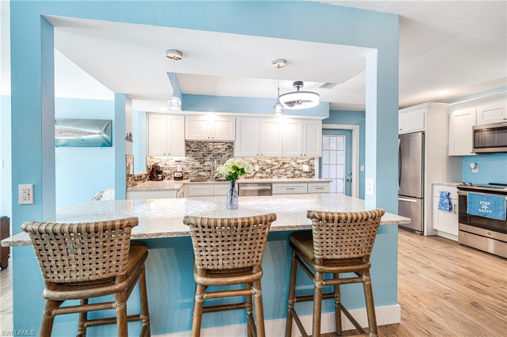 4817-4819 Gary Road Bonita Springs, FL 34134 - Photo 7 of 48 a dining room with furniture and wooden floor