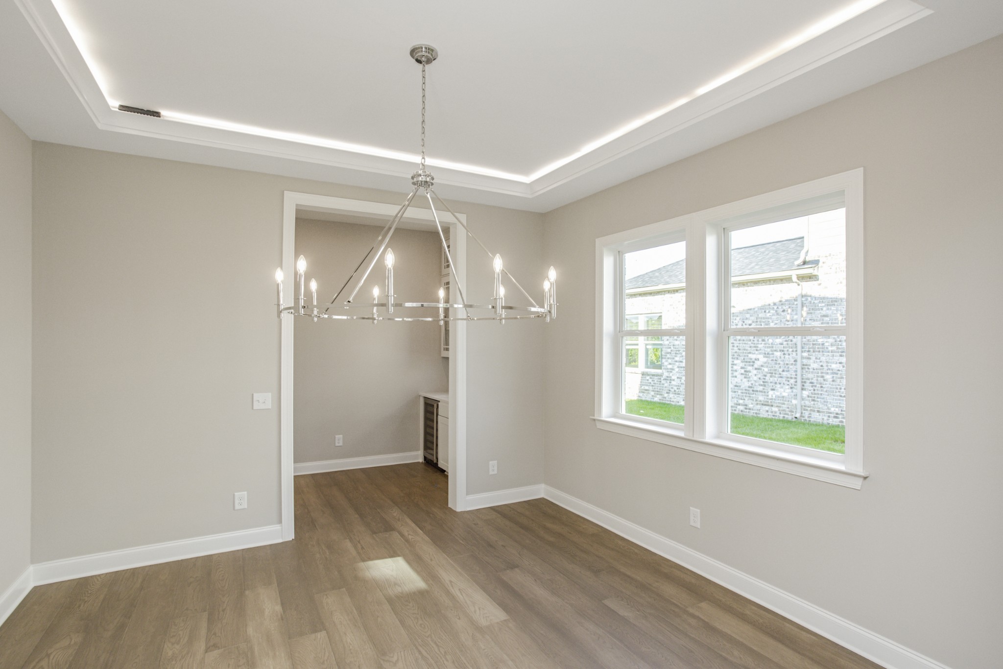 7005 Thunderhead Way Spring Hill, TN 37174 - Photo 14 of 63 a view of a room with wooden floor chandeliers and kitchen view