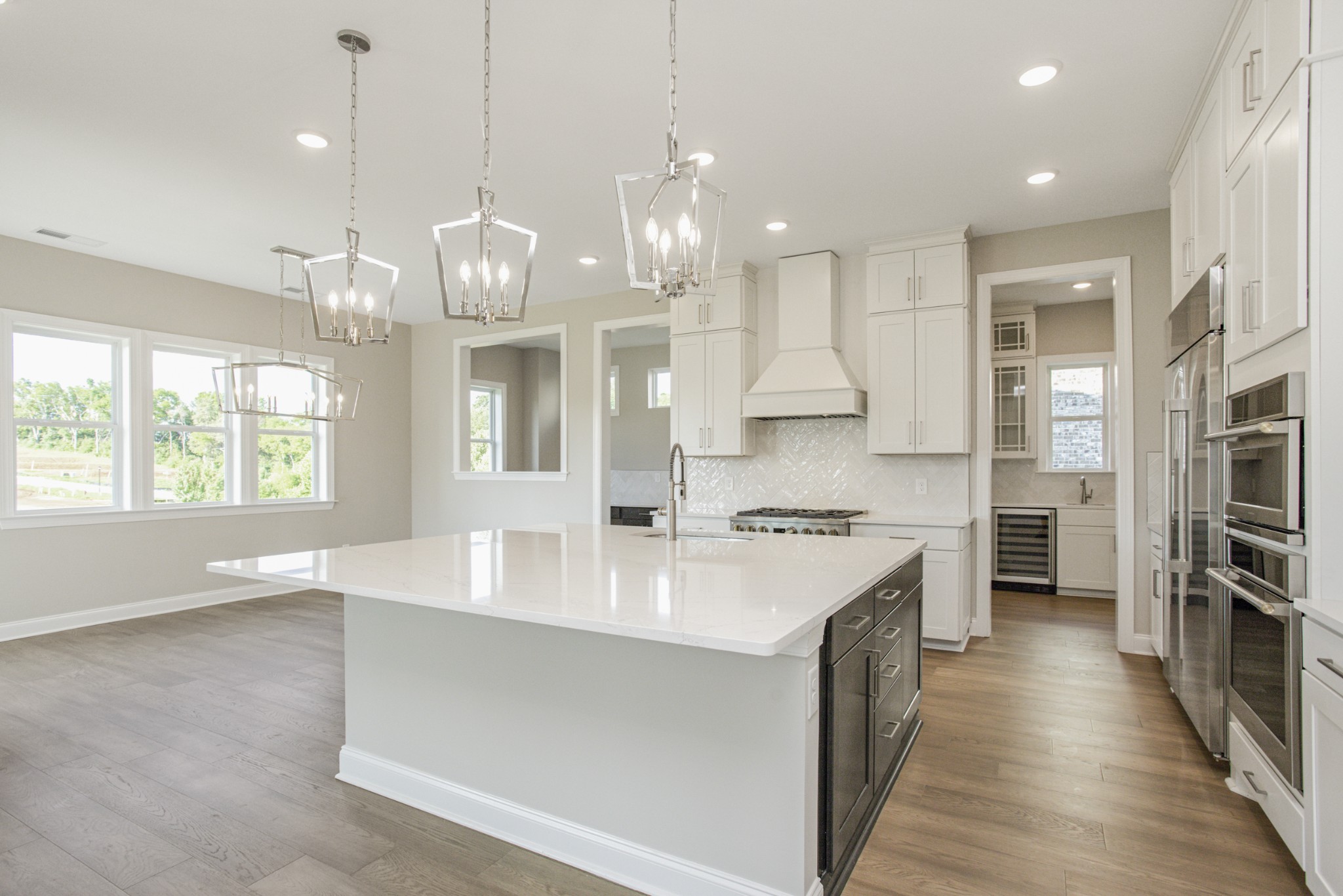 7005 Thunderhead Way Spring Hill, TN 37174 - Photo 23 of 63 a large kitchen with kitchen island a stove a sink a center island and windows