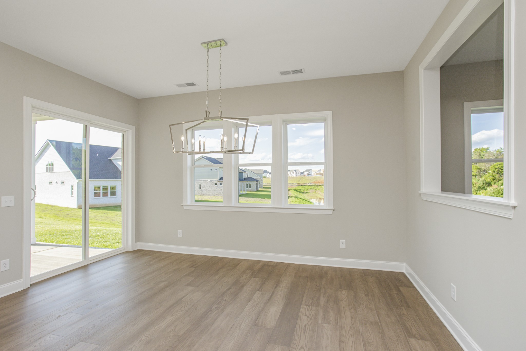 7005 Thunderhead Way Spring Hill, TN 37174 - Photo 27 of 63 a view of an empty room with wooden floor and a window