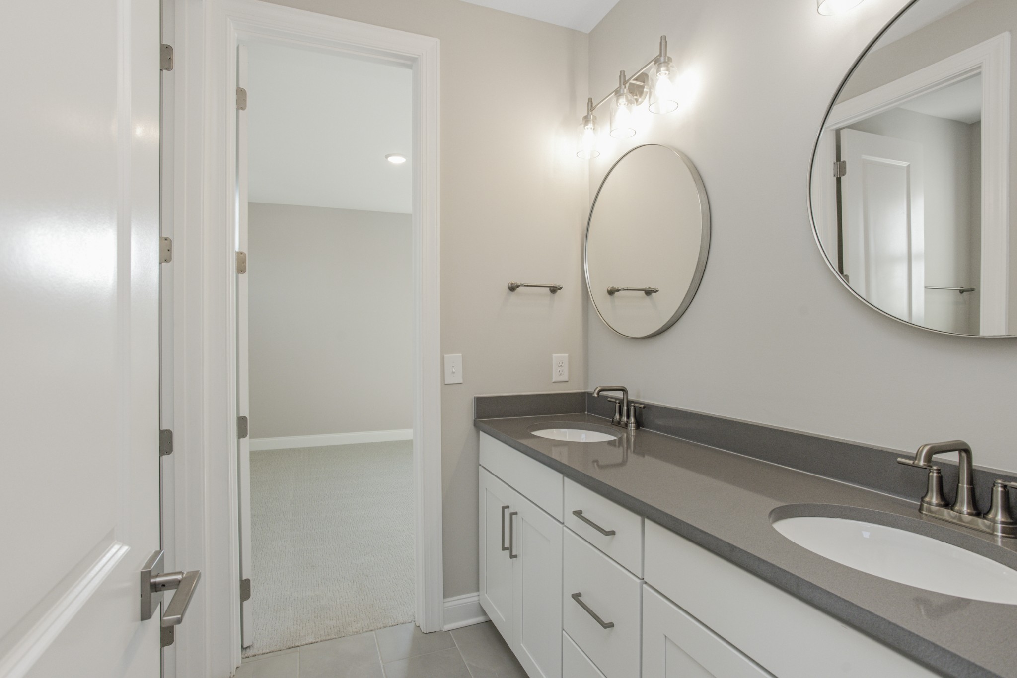 7005 Thunderhead Way Spring Hill, TN 37174 - Photo 41 of 63 a bathroom with a granite countertop sink and a mirror
