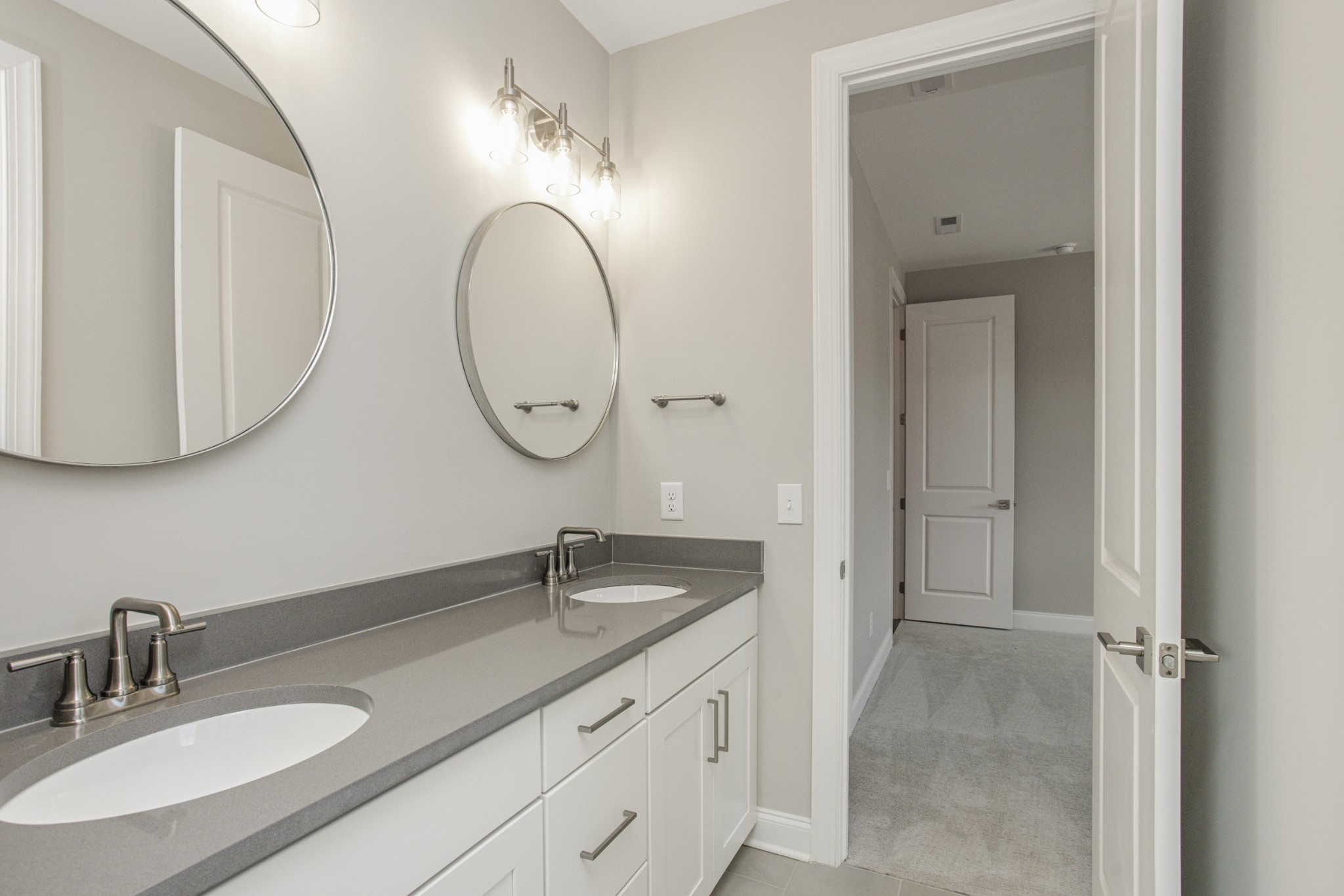 7005 Thunderhead Way Spring Hill, TN 37174 - Photo 42 of 63 a bathroom with a granite countertop double vanity sink and a mirror