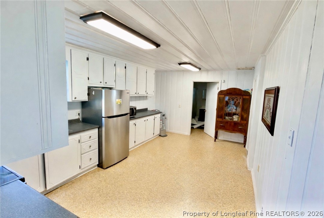 5309 Tobacco Road Orrum, NC 28369 - Photo 10 of 44 a kitchen with stainless steel appliances a refrigerator and a stove