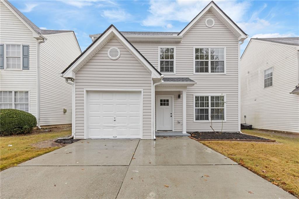 a view of house with garage