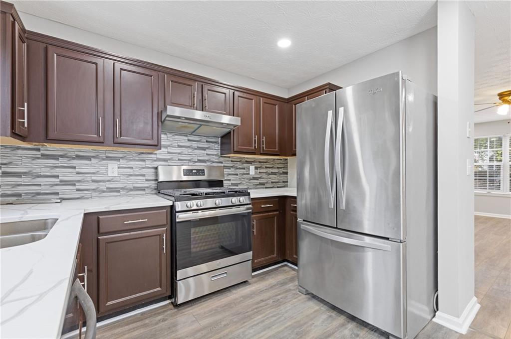 441 Spring Head Court Lawrenceville, GA 30046 - Photo 11 of 27 a kitchen with granite countertop stainless steel appliances and wooden cabinets