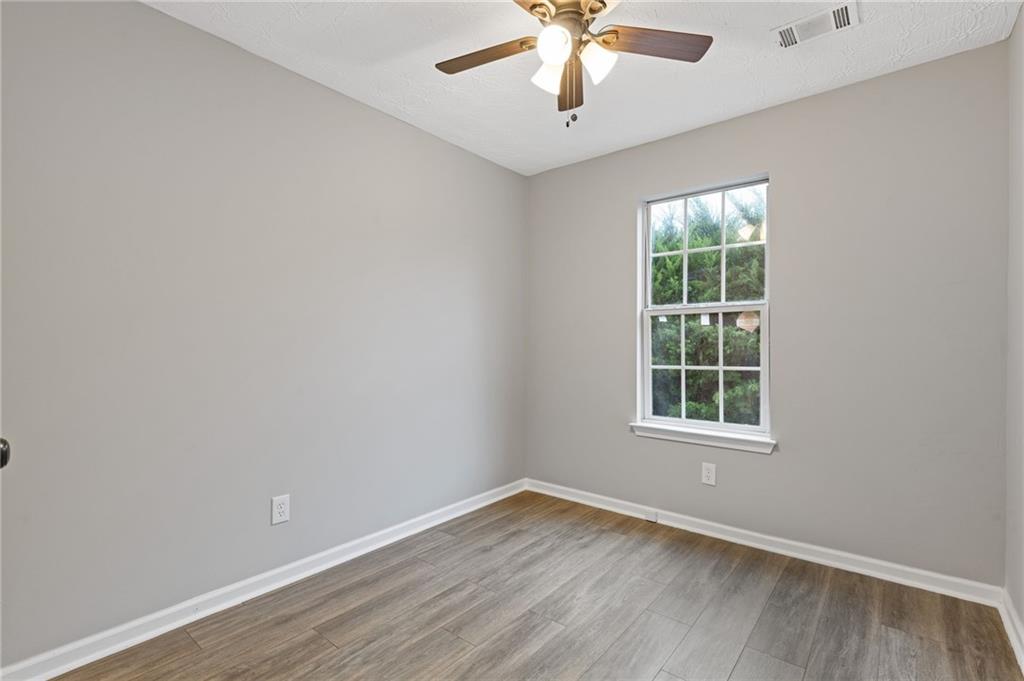 441 Spring Head Court Lawrenceville, GA 30046 - Photo 12 of 27 an empty room with a window and a fan