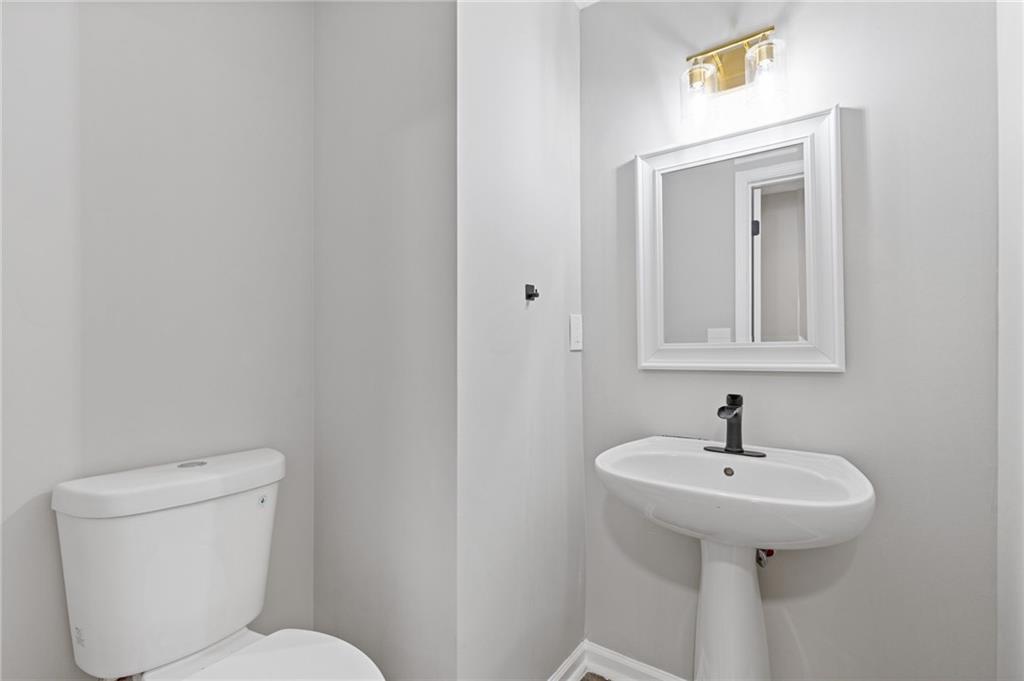 441 Spring Head Court Lawrenceville, GA 30046 - Photo 13 of 27 a bathroom with a toilet sink and mirror
