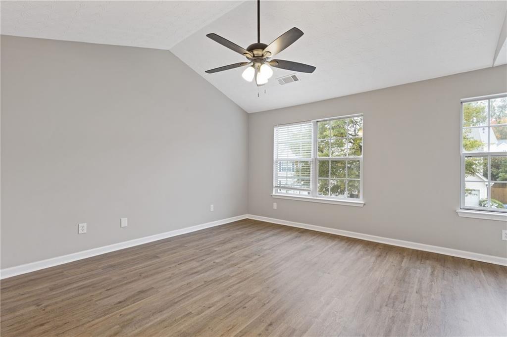 441 Spring Head Court Lawrenceville, GA 30046 - Photo 15 of 27 an empty room with wooden floor fan and windows