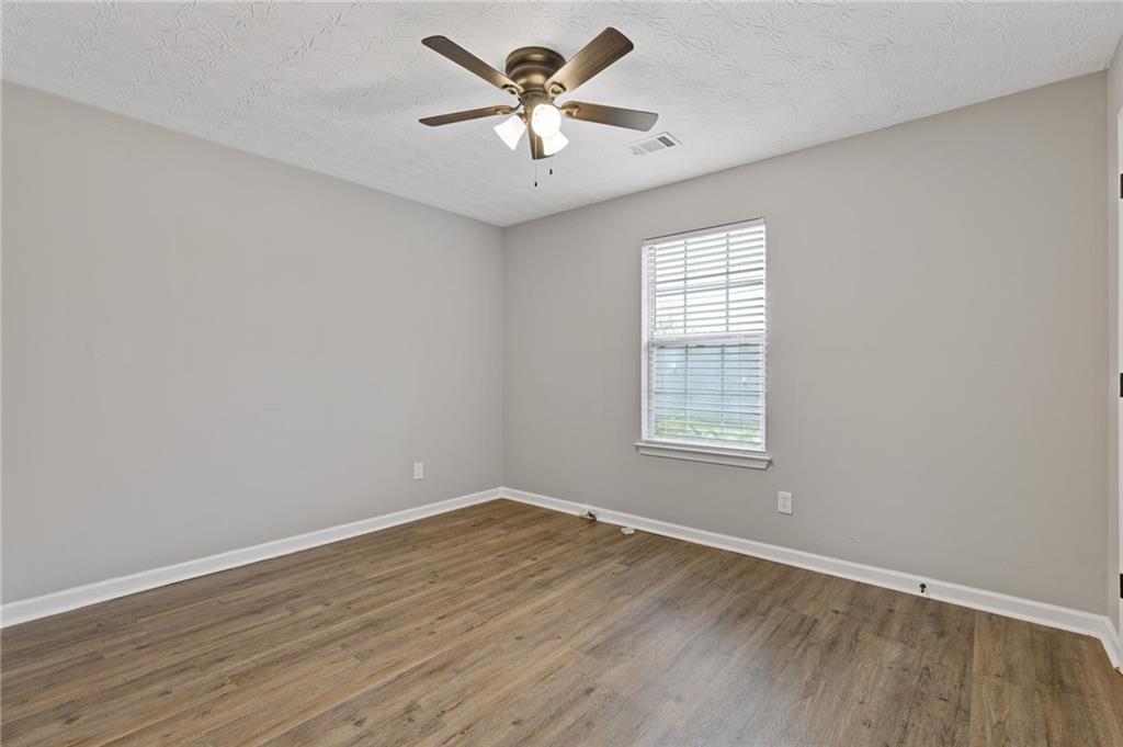 441 Spring Head Court Lawrenceville, GA 30046 - Photo 20 of 27 wooden floor in an empty room with a window