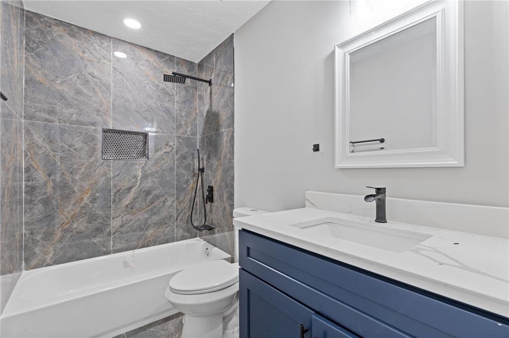441 Spring Head Court Lawrenceville, GA 30046 - Photo 21 of 27 a bathroom with a sink a toilet and shower