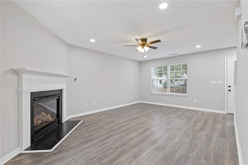 441 Spring Head Court Lawrenceville, GA 30046 - Photo 6 of 27 a view of an empty room with a fireplace and a window