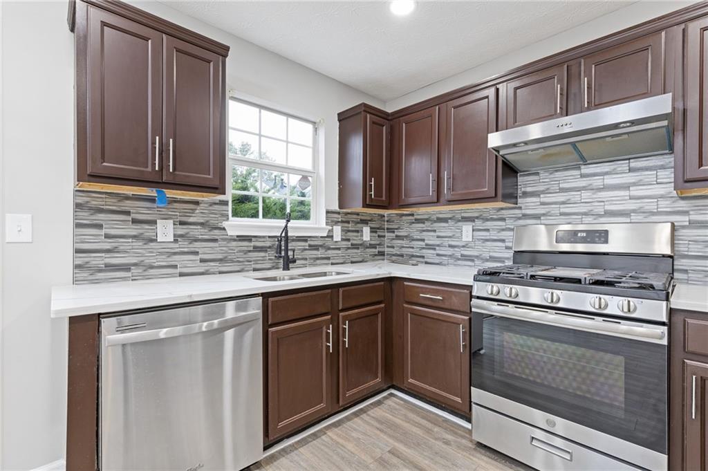 441 Spring Head Court Lawrenceville, GA 30046 - Photo 10 of 27 a kitchen with granite countertop cabinets stainless steel appliances and a sink