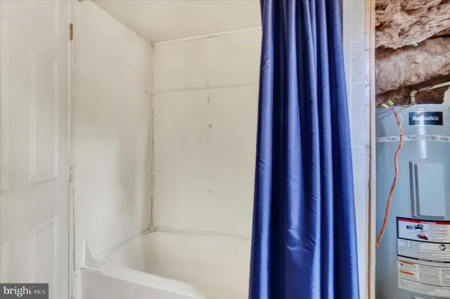 a bathroom with bathtub and shower