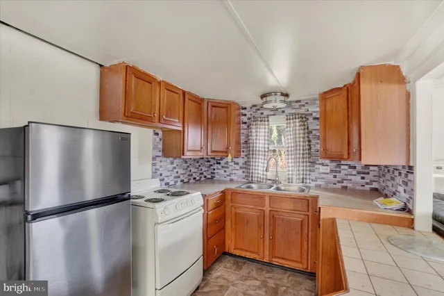 a kitchen with stainless steel appliances a refrigerator sink and cabinets