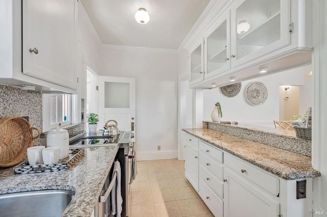 a bathroom with granite countertop double vanity and a mirror