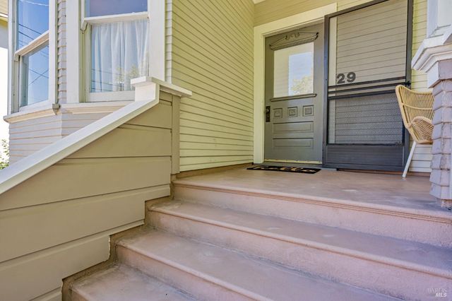 a view of a house with a chair and wooden floor