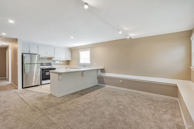 a kitchen with stainless steel appliances a refrigerator sink and cabinets