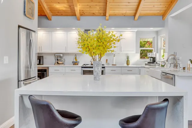 a bathroom with a granite countertop sink toilet tub and shower