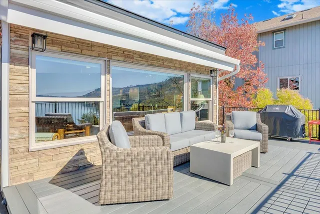 a view of a patio with a table and chairs under an umbrella
