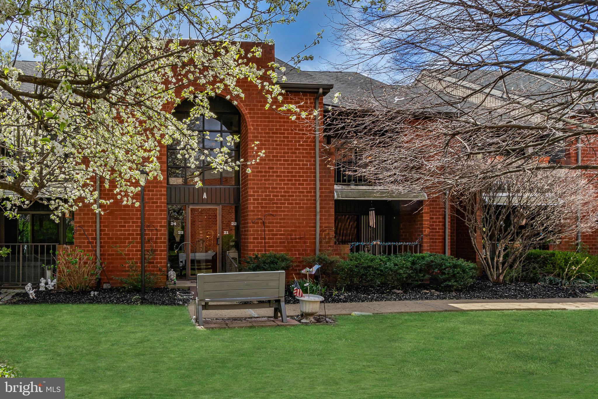 a view of a chair and table in backyard of the house