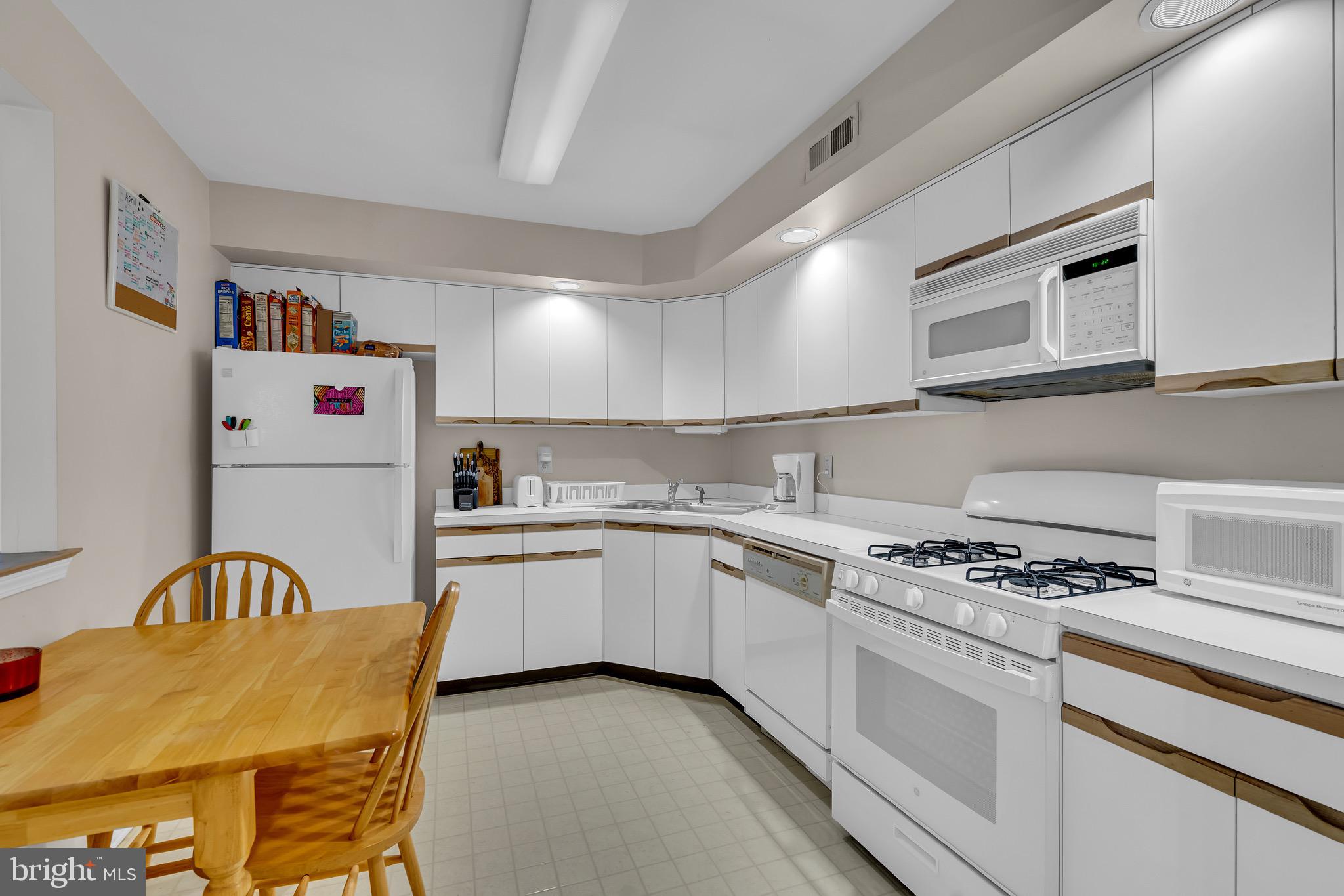 2015 Welsh Road, Unit A22 Philadelphia, PA 19115 - Photo 11 of 27 a kitchen with stainless steel appliances granite countertop a stove and a sink