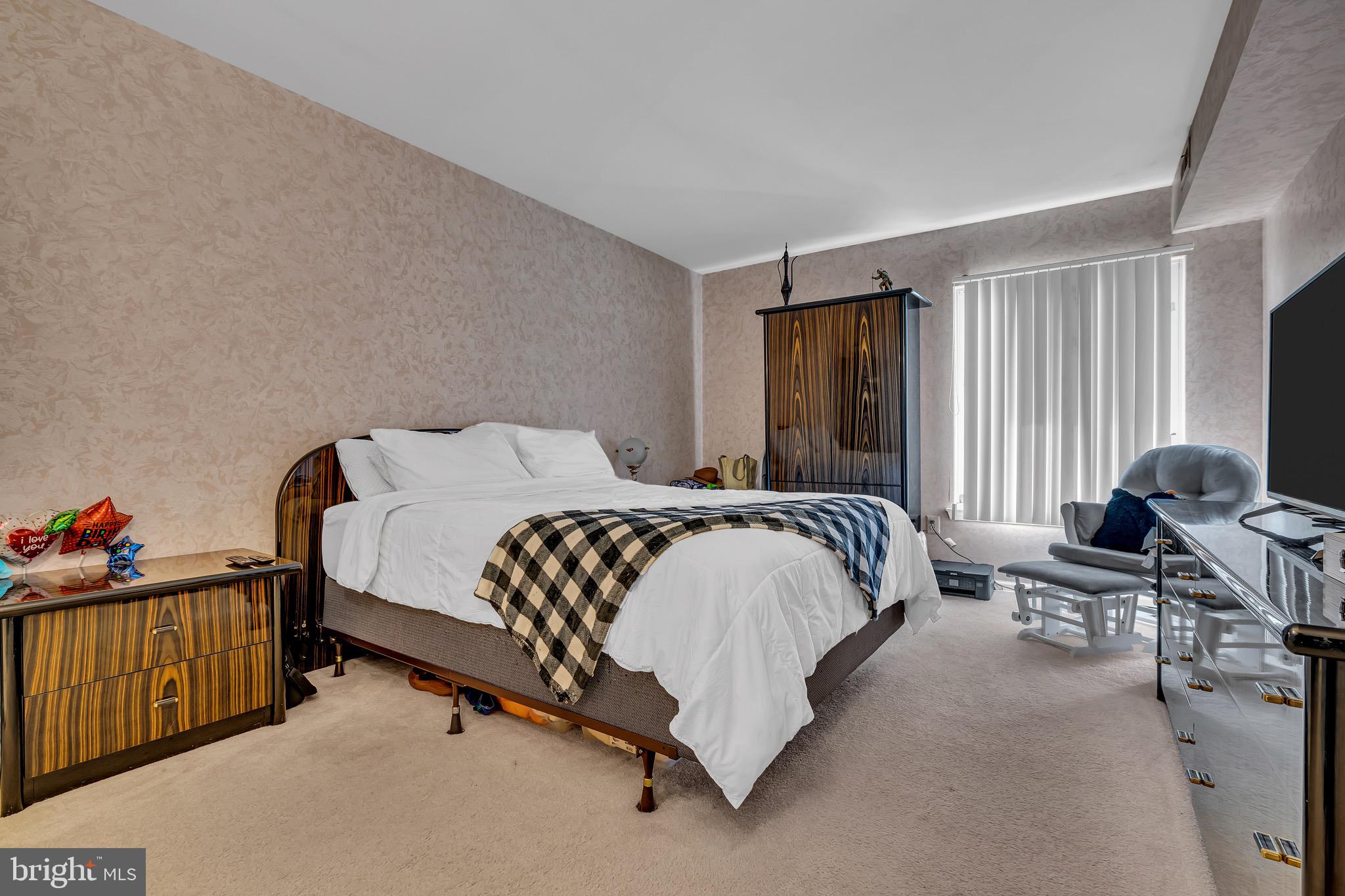 2015 Welsh Road, Unit A22 Philadelphia, PA 19115 - Photo 18 of 27 a bedroom with a bed and a flat tv screen