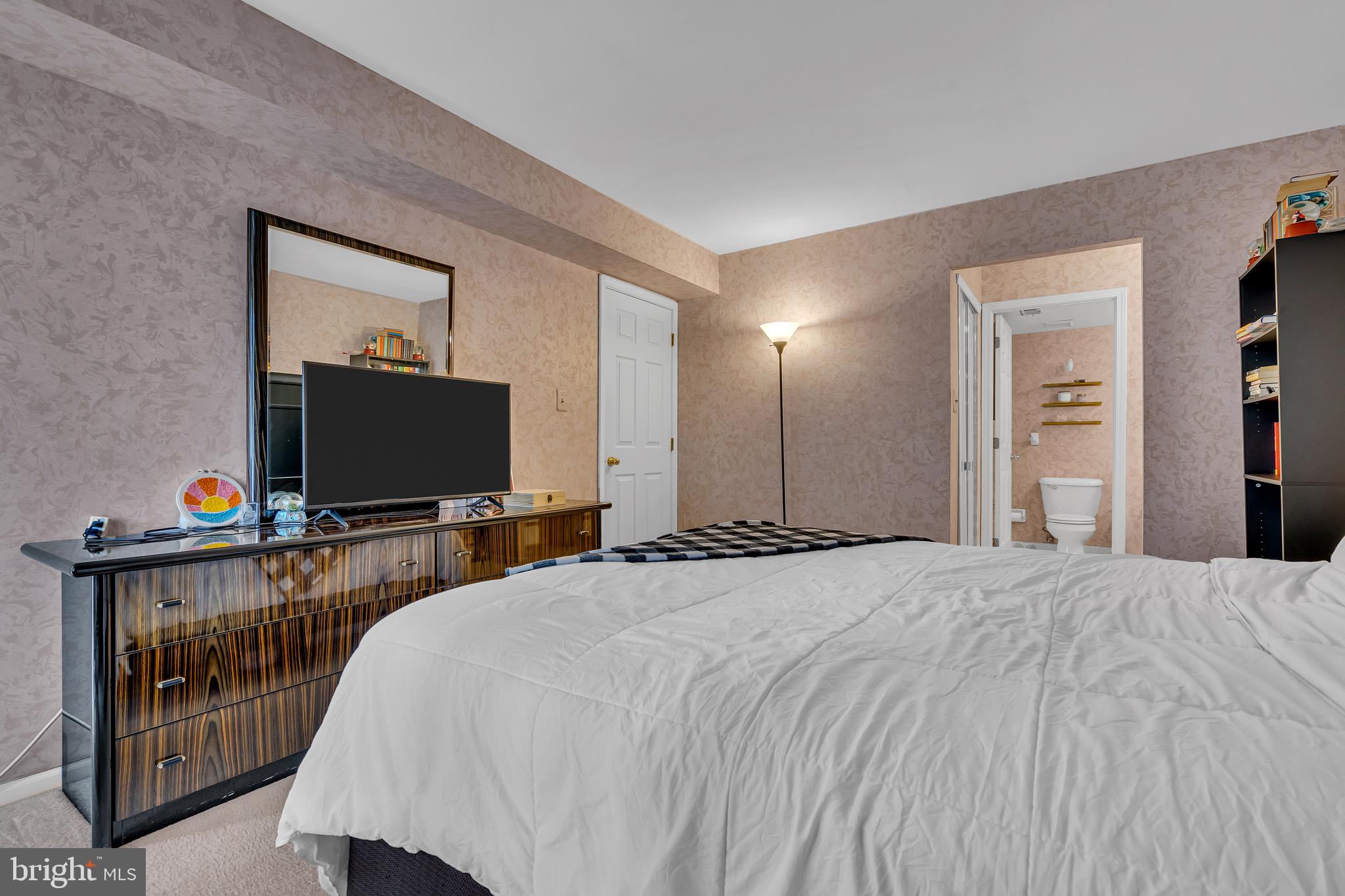 2015 Welsh Road, Unit A22 Philadelphia, PA 19115 - Photo 19 of 27 a bedroom with bed and flat screen tv