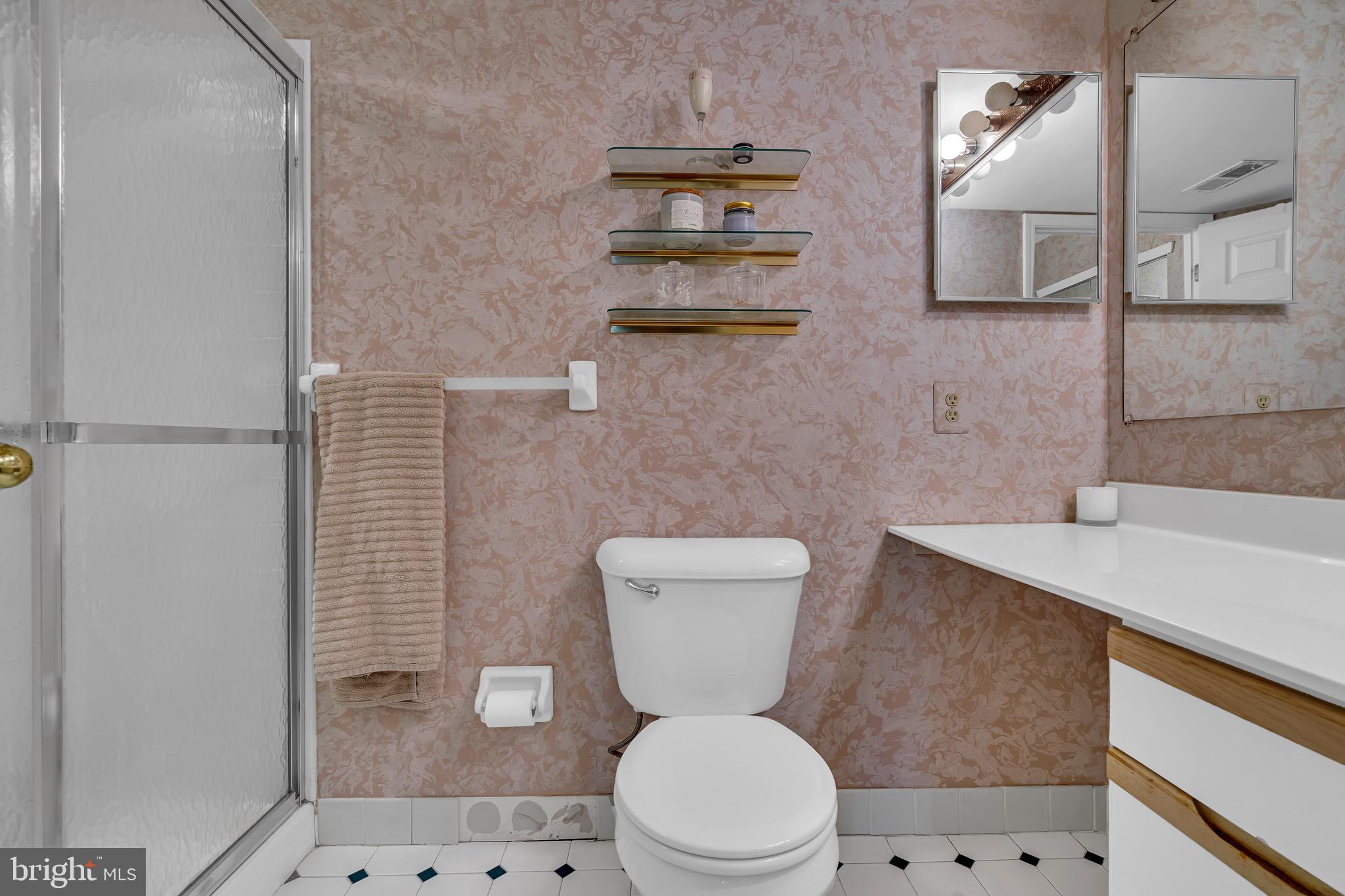 2015 Welsh Road, Unit A22 Philadelphia, PA 19115 - Photo 22 of 27 a white toilet sitting next to a bathroom sink and a mirror