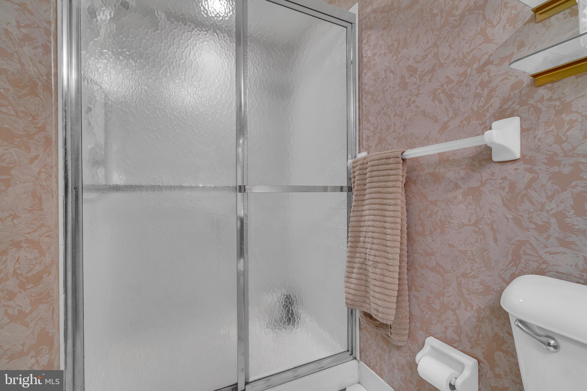 2015 Welsh Road, Unit A22 Philadelphia, PA 19115 - Photo 23 of 27 a bathroom with a shower and toilet