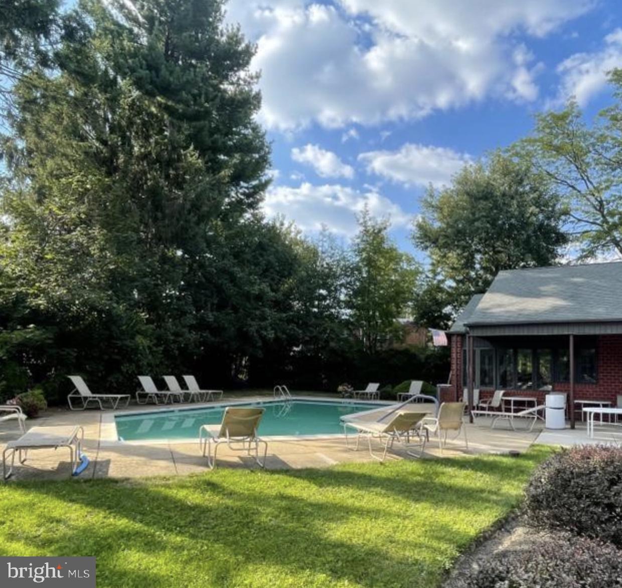2015 Welsh Road, Unit A22 Philadelphia, PA 19115 - Photo 26 of 27 a view of swimming pool with lawn chairs and a big yard