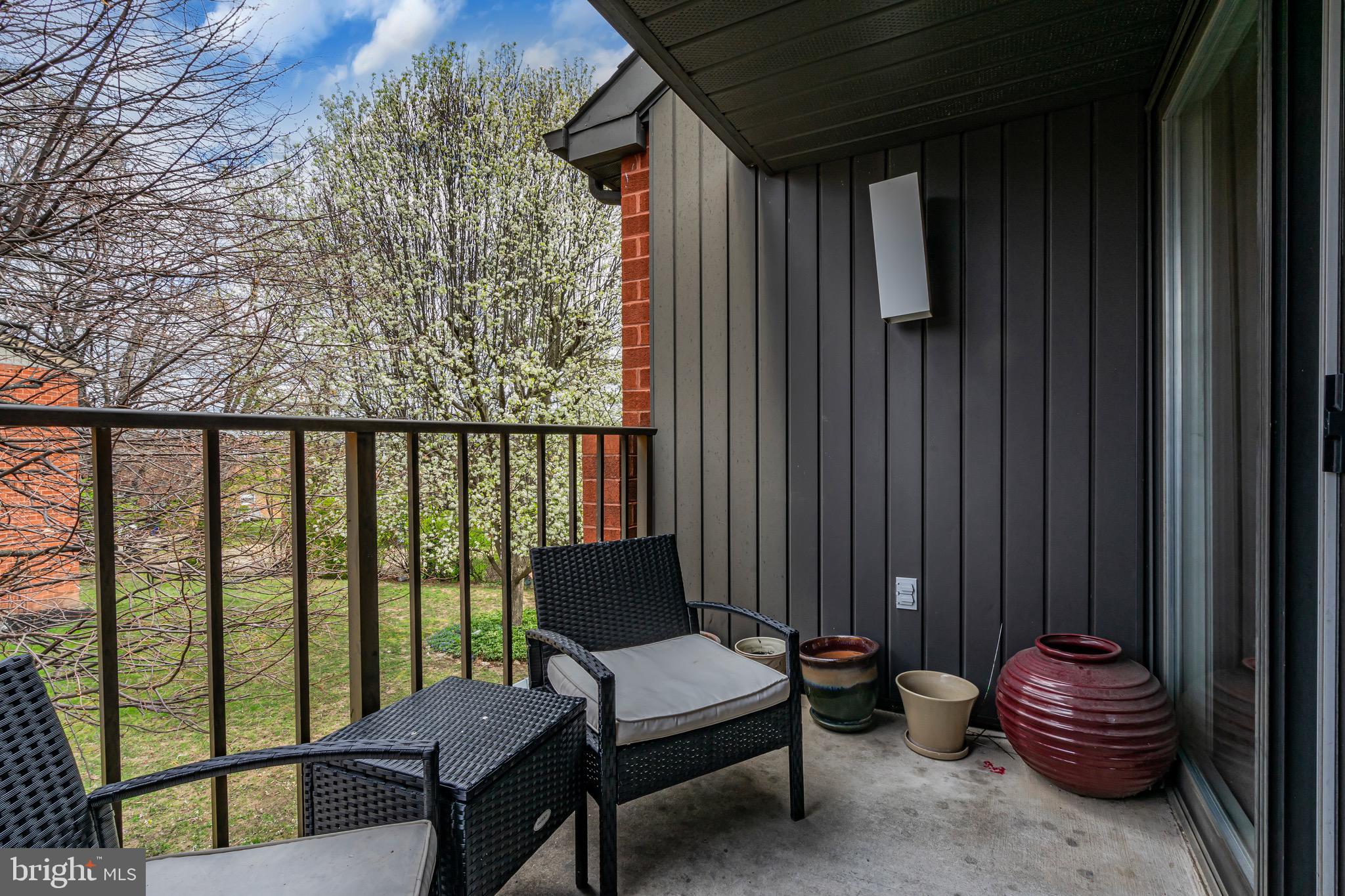 2015 Welsh Road, Unit A22 Philadelphia, PA 19115 - Photo 6 of 27 a balcony with chairs and with potted plants