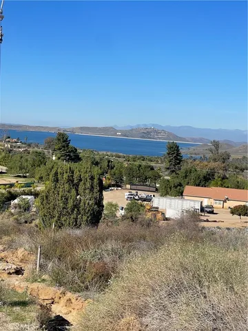 a view of a dry yard with trees