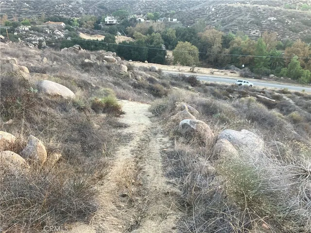 a view of a dry yard with mountains
