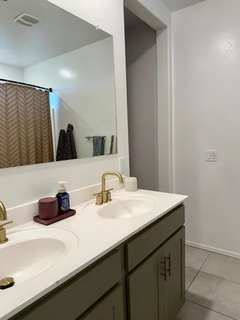 a bathroom with a sink vanity and a mirror