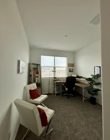 a living room with furniture a window and a table