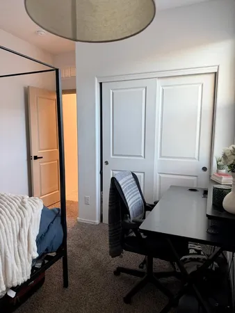 a bedroom with a bed and a table